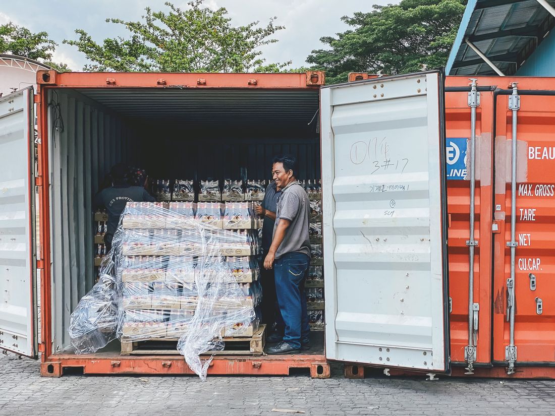 Pallets being loaded into a container at a supplier site